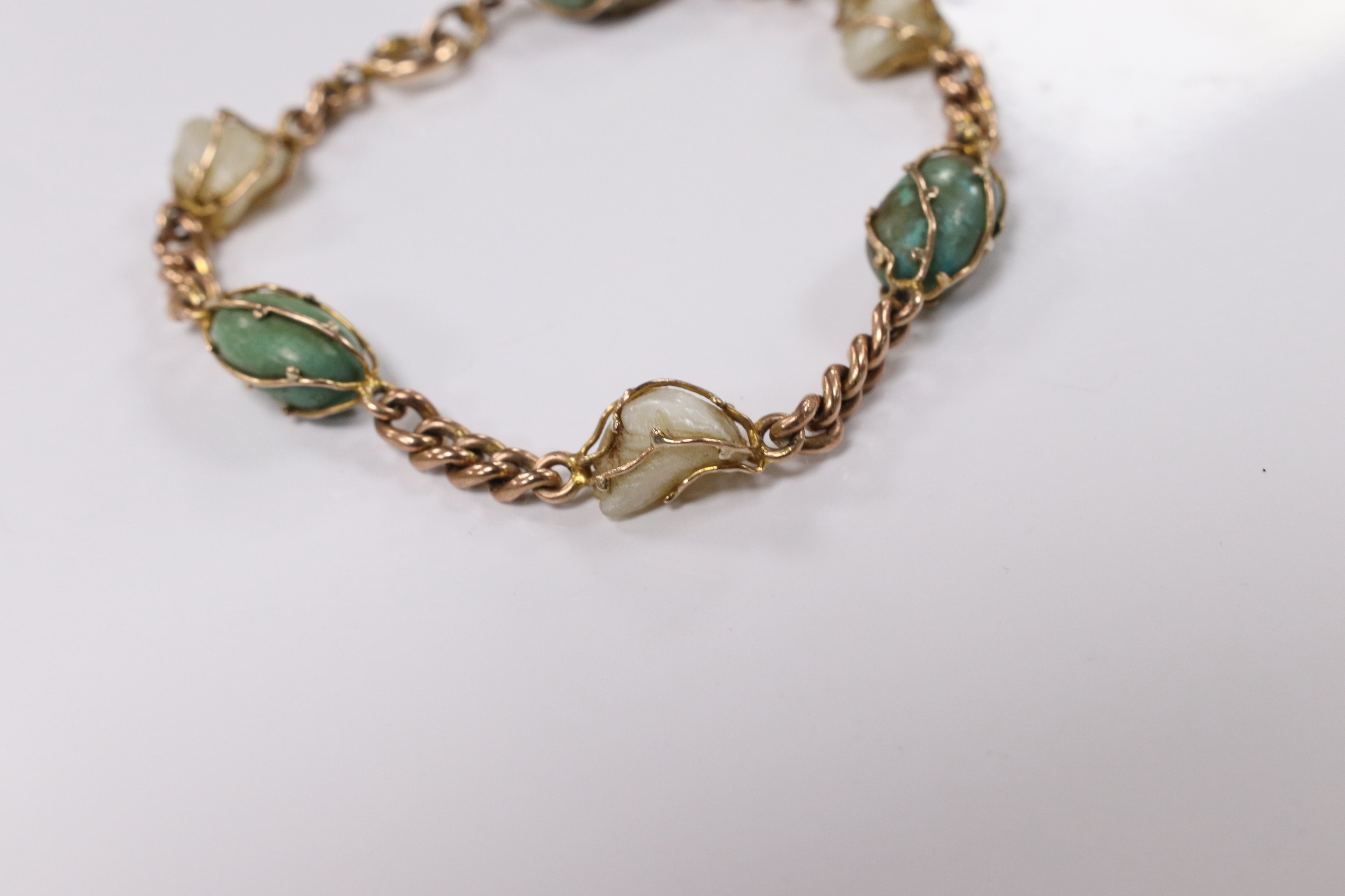 An early 20th century yellow metal, turquoise and baroque pearl set curb link bracelet, 18cm, gross weight 11.1 grams. Condition - fair